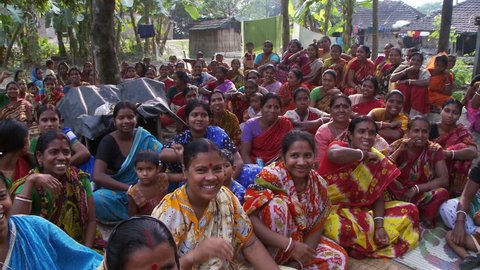 Baruipur, India - CIRCA 2013 - Women chanting, walking and raising arms at women meeting
