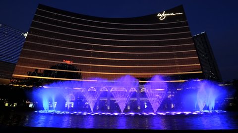 MACAU, CHINA - SEPTEMBER 14, 2013: View to the show of the dancing fountains in front of the Wynn hotel in Macau, China.