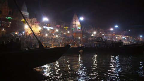 Varanasi, India - CIRCA 2013 - Floating past boat of viewers watching fire Puja Ceremony