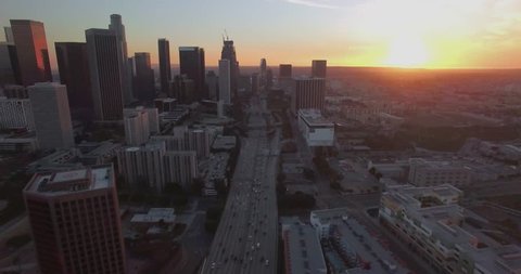 Above Downtown Traffic / Aerial 4K footage flying above downtown Los Angeles traffic during sunset/sunrise with clear skies and minimal traffic.