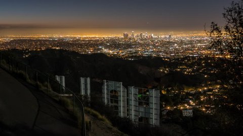LOS ANGELES, CALIFORNIA, USA - January 24, 2016:  Editorial sunrise time lapse with zoom from the back of the Hollywood Sign in popular Griffith Park.  