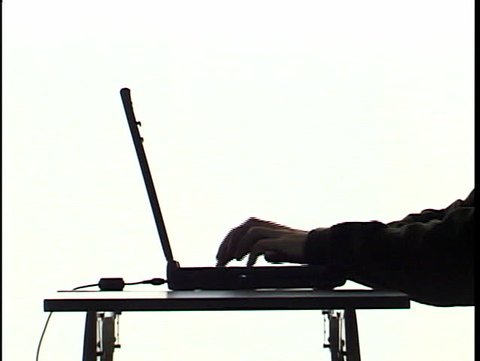 typing on laptop in silhouette 1