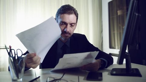 boss overwhelmed by too much paperwork in the stress and sad