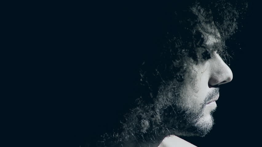 Handsome man in darkness suffering strong pain feeling sad closeup