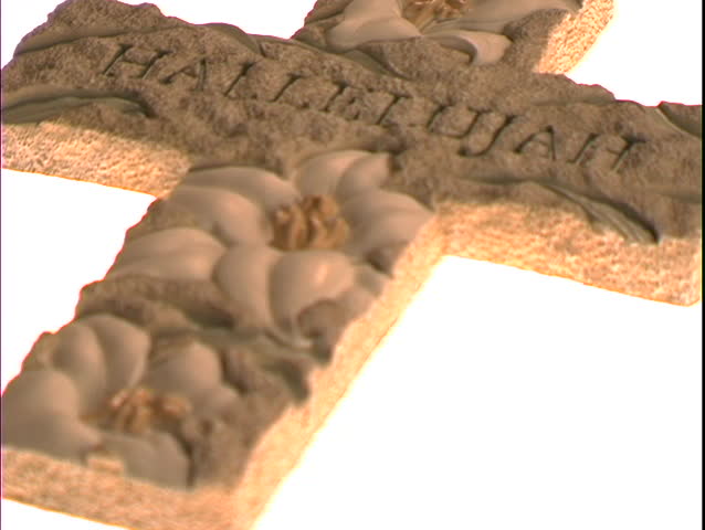The word Hallelujah and lilies decorate a Christian cross.