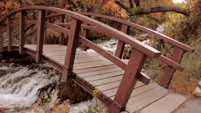 A beautiful footbridge over a mountain stream during the fall season with