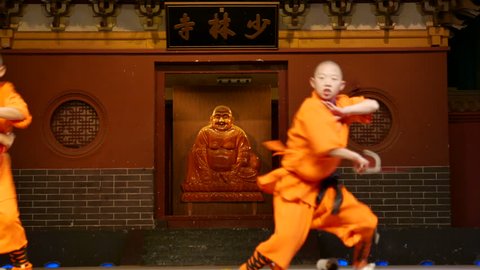 Dec.18,2015-Dengfeng,China: Shaolin temple monks are practicing martial skills on the stage for the tourists