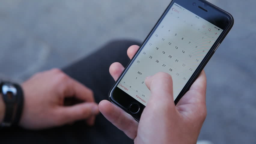 Close-up male hands scrolling screen on smartphone. Person using calendar app on the mobile device. Royalty-Free Stock Footage #14237996