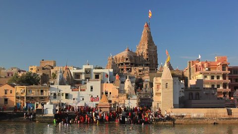 DWARKA, INDIA - JANUARY 3: Hindu pilgrims take a holy bath in the river Gomti. View of Gomti Ghat and Krishna temple Shree Dwarkadhish on January 3, 2016 in Dwarka