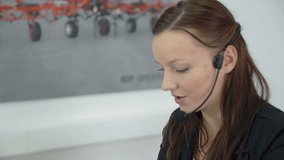 In this video, we can see that an operator is asking her client some questions on the phone and then she is writing them down on her computer.