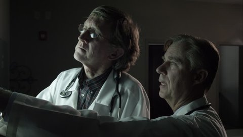 Two doctors referencing a patient's x-ray.
