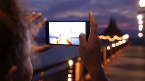 Woman Taking Night View Photos Using Mobile Phone