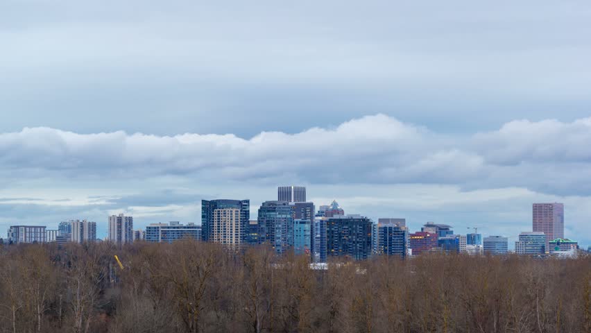 UHD 4k Time Lapse movie of moving white clouds and blue sky over downtown city of Portland Oregon from dusk into blue hour at night 4096x2304