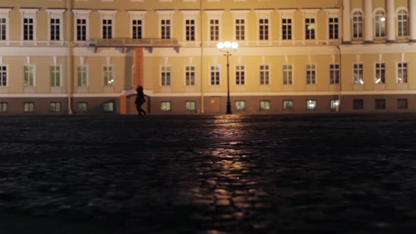 View of Palace square in Saint Petersburg in night. Silhouettes of couples.