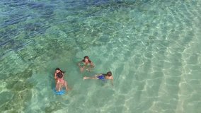 Aerial view of family swimming in caribbean sea