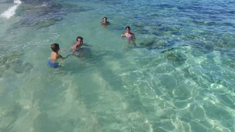 Aerial view of family swimming in caribbean sea