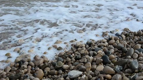 Sea surf. Waves runs on coastal pebble.