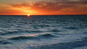 Colorful loop features the sun setting over breaking waves on the Gulf of Mexico at Lovers Key State Park near Ft. Myers, Florida.