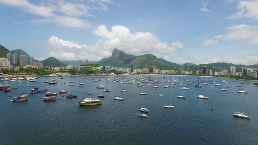 Aerial View of the Bay of Botafogo And its marina with boats moored in the classic opposite view to the Sugar Loaf Mountain with Christ Redeemer (Glory) in the background in Rio de Janeiro city. 2016