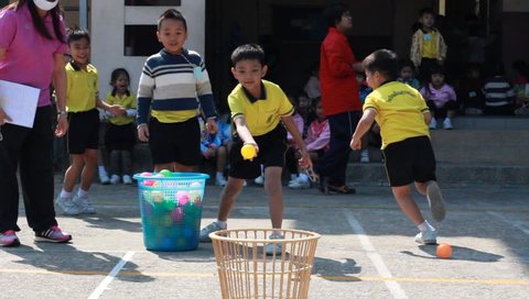 BANGKOK, THAILAND - JAN 26, 2016: Unknown children, throw the ball, kindergarten Students are studying Physical Education in Schools at kindergarten School. Pieamsuwan school in bangkok at 2016.