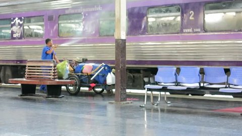 Bangkok, Thailand – May 4, 2015: People clean the train after the passengers left at Hualampong Station. It is the main train station in Bangkok that passengers used to travel around the country. 
