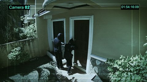 CCTV watching how Burglars breaking into a house via a door with a lockpick.
