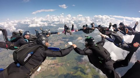 Skydiving holding hands