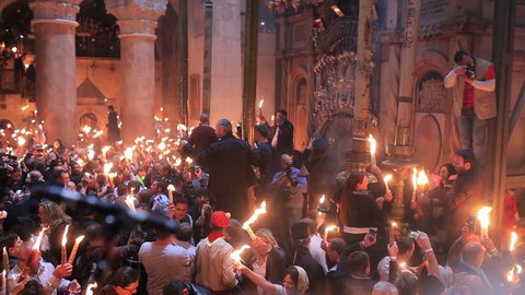 JERUSALEM, ISRAEL - APRIL 11:Christians participating at Miracle of Holy Fire in Easter Day.The Holy Fire is an immaterial  fire that comes every year in Jerusalem in Holy Sepulcher at orthodox Easter