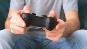 Male hands holding video game controller.