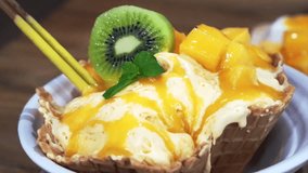 video of Famous Mango shaved ice with ice cream and custard. Tropical fruit cold sweet