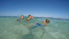 Happy family enjoying swimming in caribbean sea