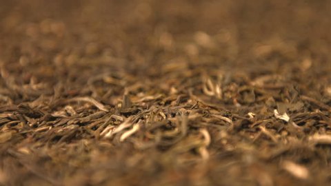 The dried green tea leaves. Vertical and horizontal  pan. Close-up. 2 shots.