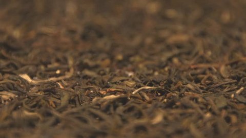 The dried green tea leaves. Two horizontal and vertical slow panorama. Close-up. 3 shots.