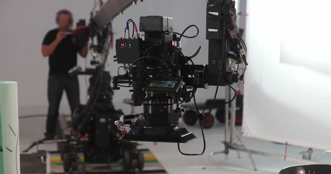 Camera jib operator moving Red Dragon upwards on professional production film set 4K Prores HQ