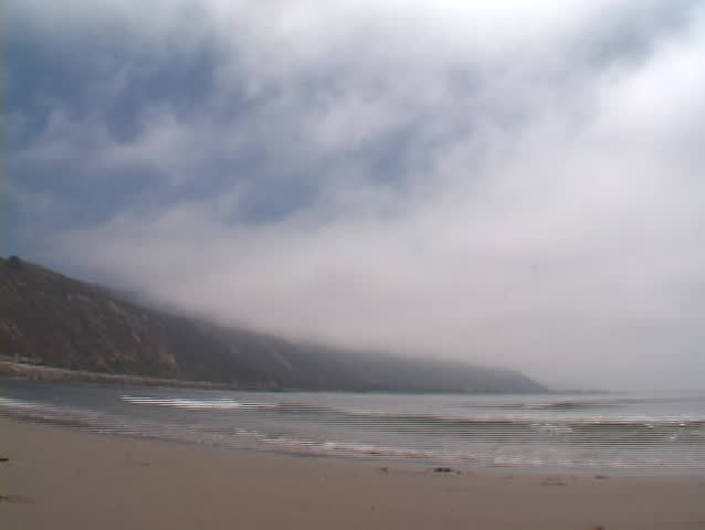 Waves rapidly roll onto a beach.