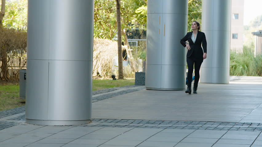 Business woman walking on a street talking on a mobile phone