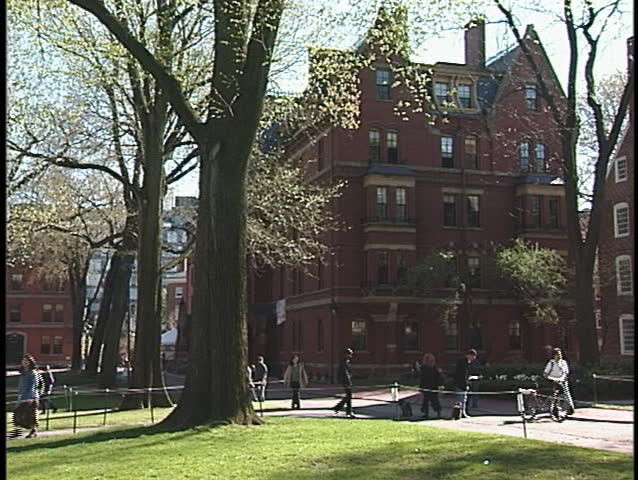 A student strolls across the courtyard at Harvard University.