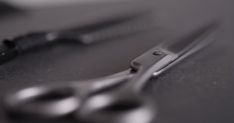 Macro shot of a barbers comb and a scissor. Shot on RED Epic.