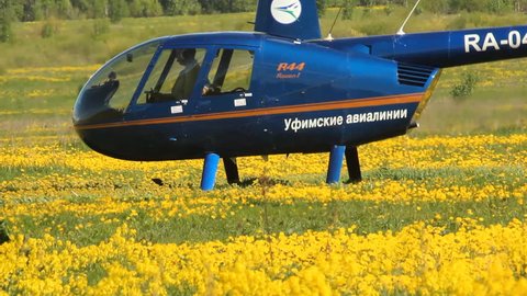 Ufa airport, - MAY 14: Landing helicopter Robinson R-44 in MAY 14, 2014 in Ufa airport, Russia 