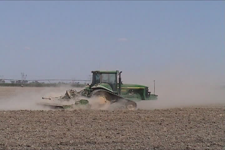 Tractor plowing the land in the farm