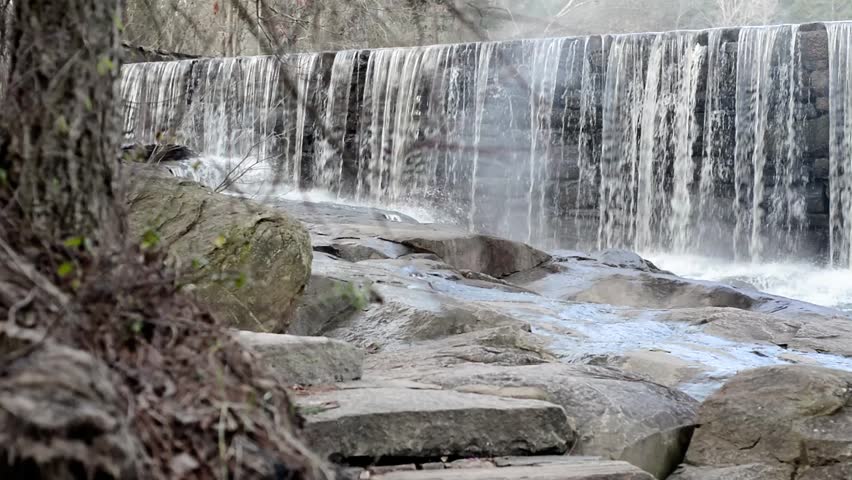 Panning shot of Historic stone dam at Yates Mill Pond in Raleigh, North Carolina