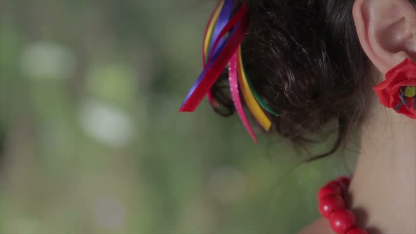 Man gently caresses woman. Tenderness of lovers. Earring in the form of a flower. Red poppy on the ear of the girl. A date lovers.