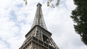 Eiffel Tower French architecture symbol tilting by the day 4K 2160p 30fps UltraHD footage - The Eiffel Tower tilt located on Paris Champ de Mars place France 4K 3840X2160 UHD video
