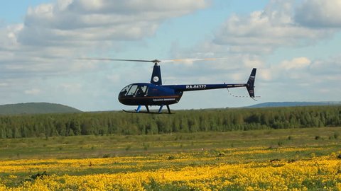 Ufa airport, - MAY 14: Landing helicopter Robinson R-44 in MAY 14, 2014 in Ufa airport, Russia