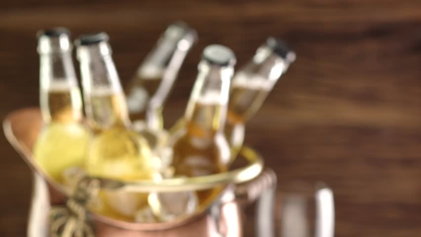 Man opens a bottle of beer and pours it into a glass. | Shutterstock HD Video #14391349