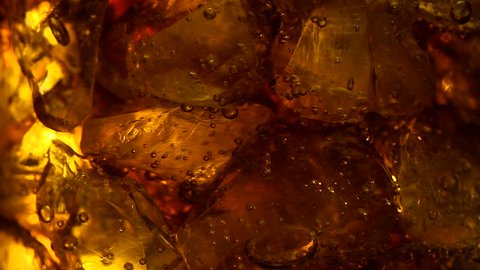 cola soft drink bubbles & ice, close-up