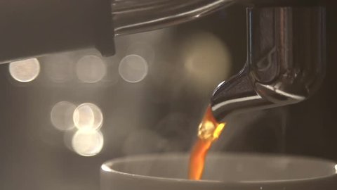 Coffee flows from cofee machine in slow motion
