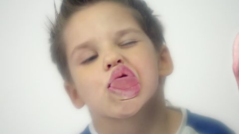 Naughty child making funny faces and having fun in slow motion