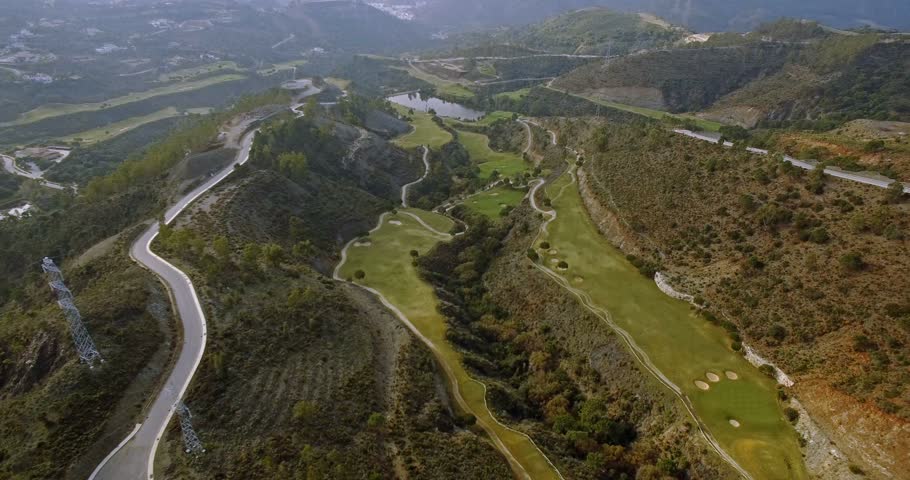 4K Aerial, View on golf course and hairpin bends, Andalusia, Spain -  graded shots. Watch for the native versions, straight out of the camera in my portfolio. Royalty-Free Stock Footage #14397862