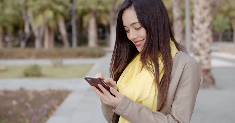 Stylish woman checking a message on her mobile